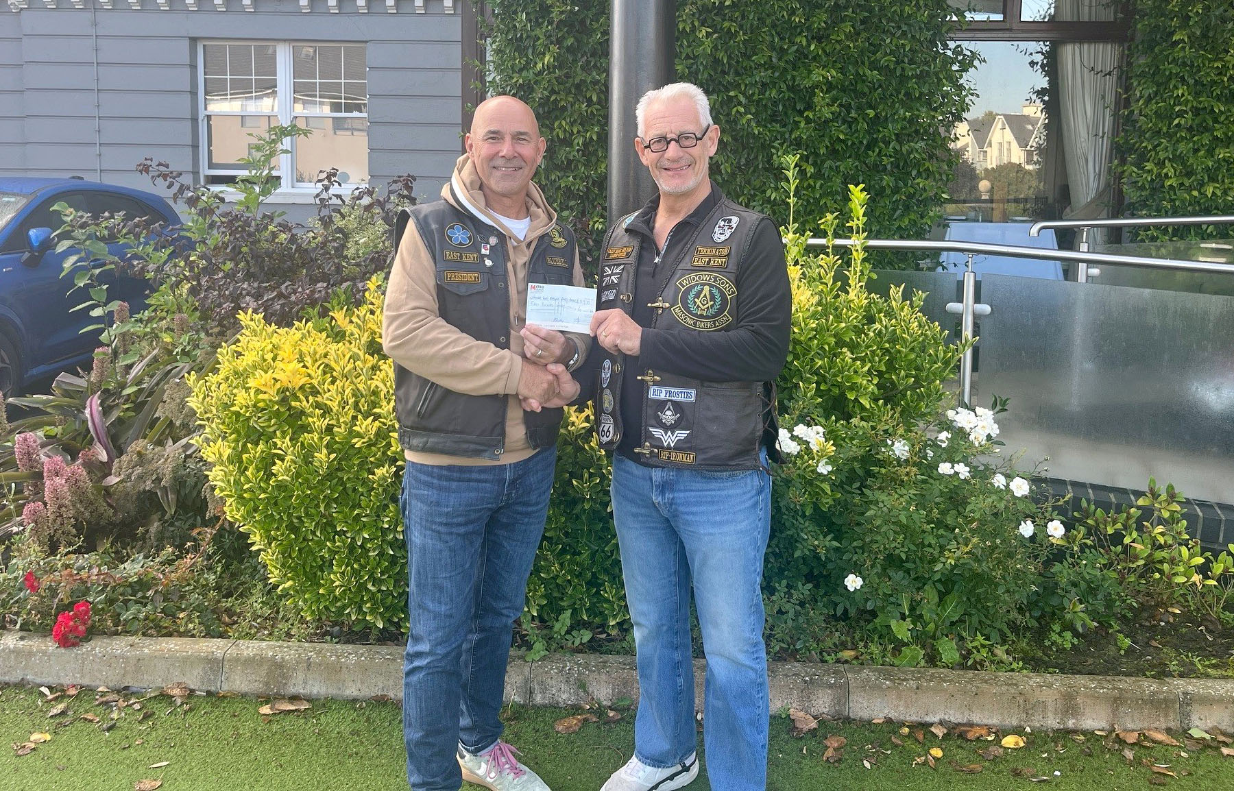 The Terminator (W.Bro. Ivor Spencer) presents a cheque for £50 to Bluebell better known as  Jason Davies-Baker the President of the East Kent Chapter
