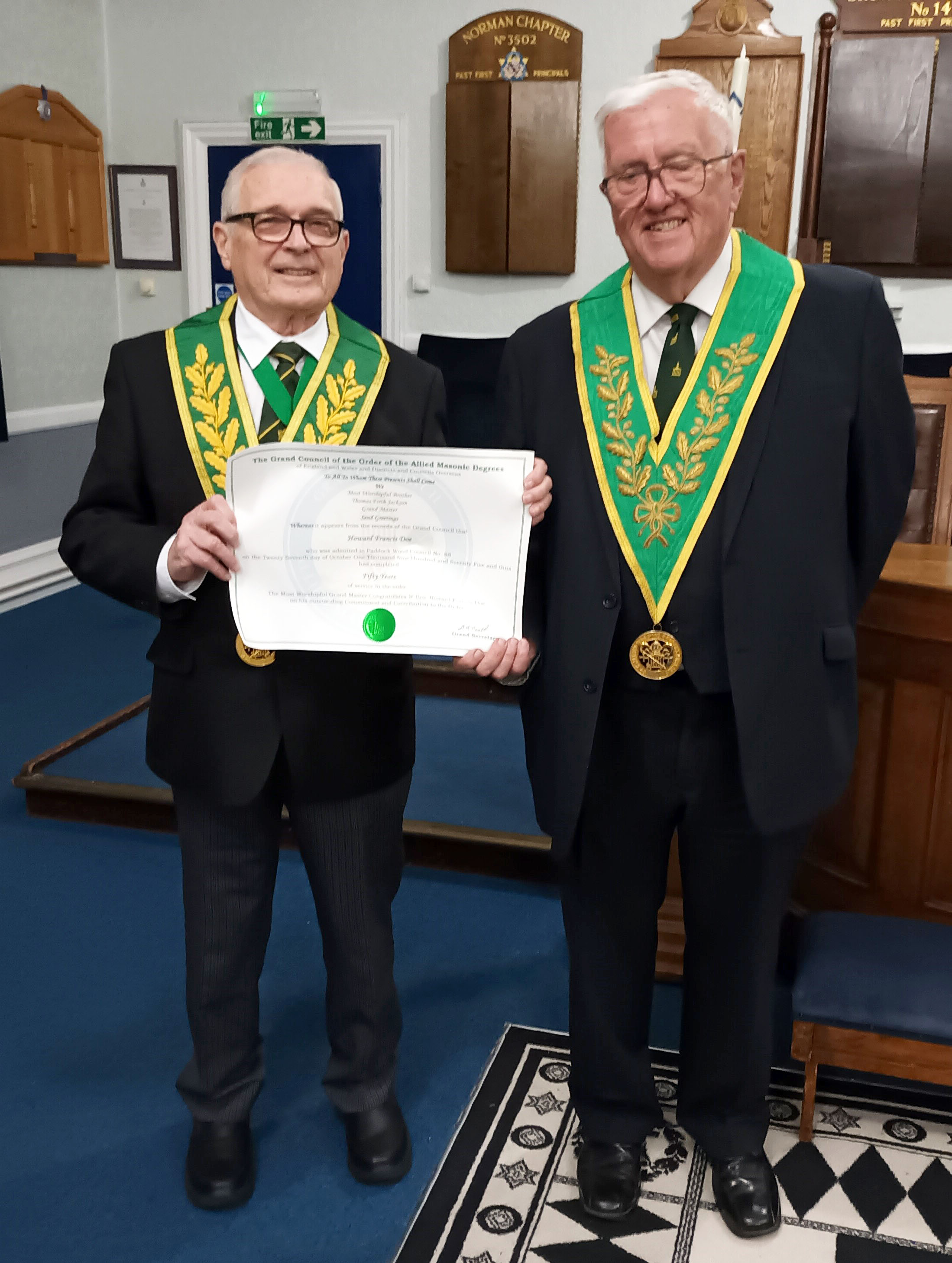 W.Bro. Derek Wilkins presents W.Bro. Howard Doe with a Certificate marking 50 years of Service to the A.M.D.
